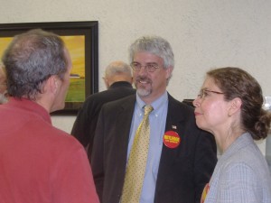 Jim Rutledge (center) discusses a point as his campaign manager (right) looks on.
