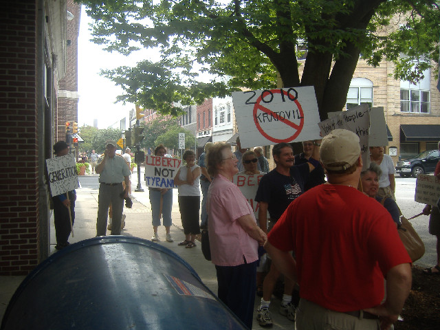 The protestors are gathered in front of Congressman Frank Kratovil's Salisbury regional office. They had the occasional honk from Main Street traffic.